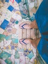 Young man feet on trencadis floor with flip flops and swimwear