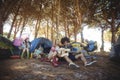 Young man with female friend playing guitar at campsite Royalty Free Stock Photo