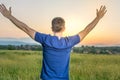 Young man in a field of wheat at sunset Royalty Free Stock Photo