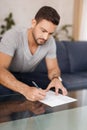 Young man filling model release on glass desk Royalty Free Stock Photo