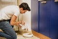 Young Man Filling Pet Bowl with Dry Food Royalty Free Stock Photo