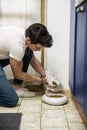 Young Man Filling Pet Bowl with Dry Food Royalty Free Stock Photo