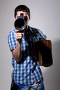 Young man filmmaker with old movie camera and a suitcase in his