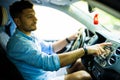 Young man finger pressing emergency button on car dashboard Royalty Free Stock Photo