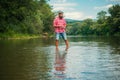 Young man fishing. Fisherman with rod, spinning reel on river bank. Man catching fish, pulling rod while fishing on lake Royalty Free Stock Photo