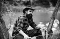 Young man fishing. Fisherman with rod, spinning reel on river bank. Man catching fish, pulling rod while fishing on lake Royalty Free Stock Photo