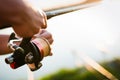 Young man fishing on lake at sunset enjoying hobby Royalty Free Stock Photo