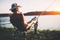 Young man fishing at pond and enjoying hobby Royalty Free Stock Photo