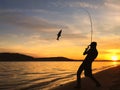 Young man fishing at sunset Royalty Free Stock Photo