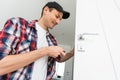 Young man fixing a door lock Royalty Free Stock Photo
