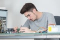 young man fixing electronic circuits closeup