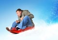 Young man flies on sled in the snow