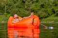 Young man floats on an air sofa Royalty Free Stock Photo