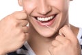 Young man flossing teeth on white background, closeup Royalty Free Stock Photo