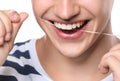 Young man flossing teeth on white background, closeup Royalty Free Stock Photo