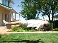 Young man flying or levitating over grass Royalty Free Stock Photo