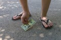 A young man found money on the road and picked up dollars