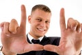 Young man framing his face with hand gesture Royalty Free Stock Photo