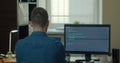 Young man freelancer coding html and programming on two screen Monitors, development web, developer. Royalty Free Stock Photo