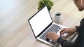 Young man freelancer sitting on couch in living room and working wit laptop computer. Royalty Free Stock Photo