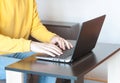 Young man freelancer student using laptop studying online working from home in internet, smiling focused millennial guy typing on Royalty Free Stock Photo