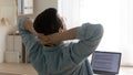 Young man freelancer taking short break of routine computer work