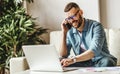 Young man freelancer working at home on a computer