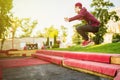 Young man freerun in summer city public park running, jumping and flying, parkour concept Royalty Free Stock Photo