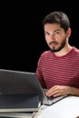 Young man in front of laptop hands over keyboard Royalty Free Stock Photo