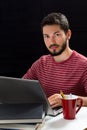 Young man in front of laptop hands over keyboard Royalty Free Stock Photo