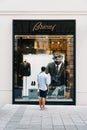 Young man in front of luxury fashion storefront