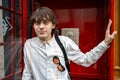 Young man in front of red telephone booth, London Royalty Free Stock Photo