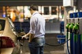 Young man fueling his car