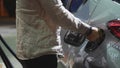 Young man fueling his car at gas station