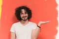 Young man with funny hair over color background