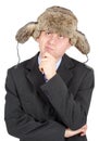 Young man in a fur hat dreams on white background Royalty Free Stock Photo