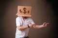 Young man gesturing with a cardboard box on his head with dollar