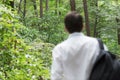 Young man is getting away from urban area to go hicking in the forest