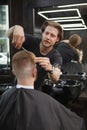 Young man getting new haircut at barbershop