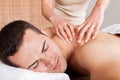 Young man getting shoulder massage Royalty Free Stock Photo