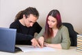 Young man and girl show with fingers on written on paper