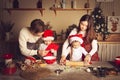 Young man and girl teach children how to cook cookies in the kitchen Royalty Free Stock Photo