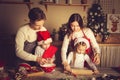 Young man and girl teach children how to cook cookies in the kitchen Royalty Free Stock Photo