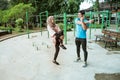 a young man and a girl in a veil chatting while standing doing warm-up movements Royalty Free Stock Photo