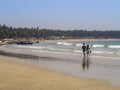 A young man and a girl walk along the Indian ocean