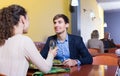 Young man and girlfriend chatting as having date