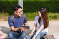 Young Man and girls friend classmates sitting consult Royalty Free Stock Photo