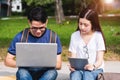 Young Man and girls friend sitting consult on laptop Royalty Free Stock Photo