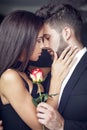 Young man give rose to lover indoor Royalty Free Stock Photo