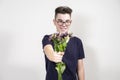 A young man gives a withered bouquet of flowers Royalty Free Stock Photo